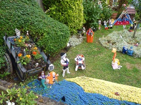 Knitted festival scene in Howard Road front garden